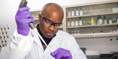 Male Charles River scientist working with a pipette and laboratory samples