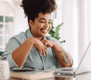 Smiling young woman on a virtual meeting on a laptop computer