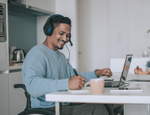 A male Charles River professional wearing a headset working from home