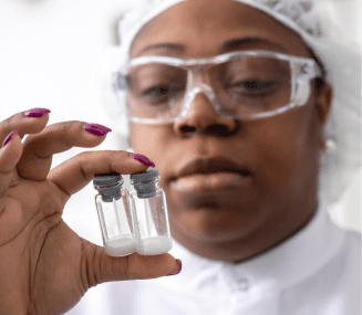 Close-up of female Charles River laboratory professional inspecting glass vials