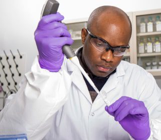 Male Charles River scientist working with a pipette and laboratory samples