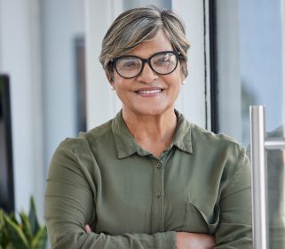 A female Charles River Labs executive smiling at the camera in an office.