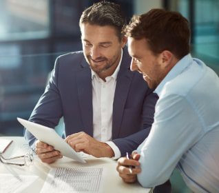 Two male Charles River Labs coporate professionals collaborating at a desk