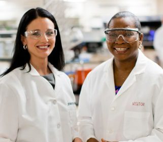 Two smiling laboratory science professional working in a at Charles River Laboratories.