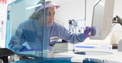 A female Charles River scientist examining results on a computer monitor