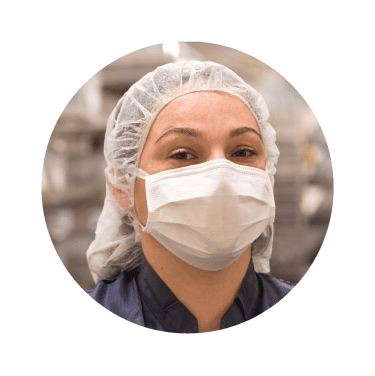 Close-up of a masked female laboratory professional