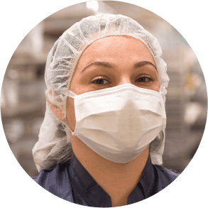 Close-up of a masked female laboratory professional