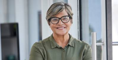 A female Charles River Labs executive smiling at the camera in an office.