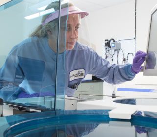 A female Charles River scientist examining results on a computer monitor