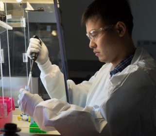 Male Charles River scientist working with a pipette and laboratory samples