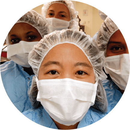 Close-up of a group of female Charles River laboratory science professionals wearing masks and caps