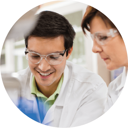 A young male Charles River laboratory professional working with a female senior scientist